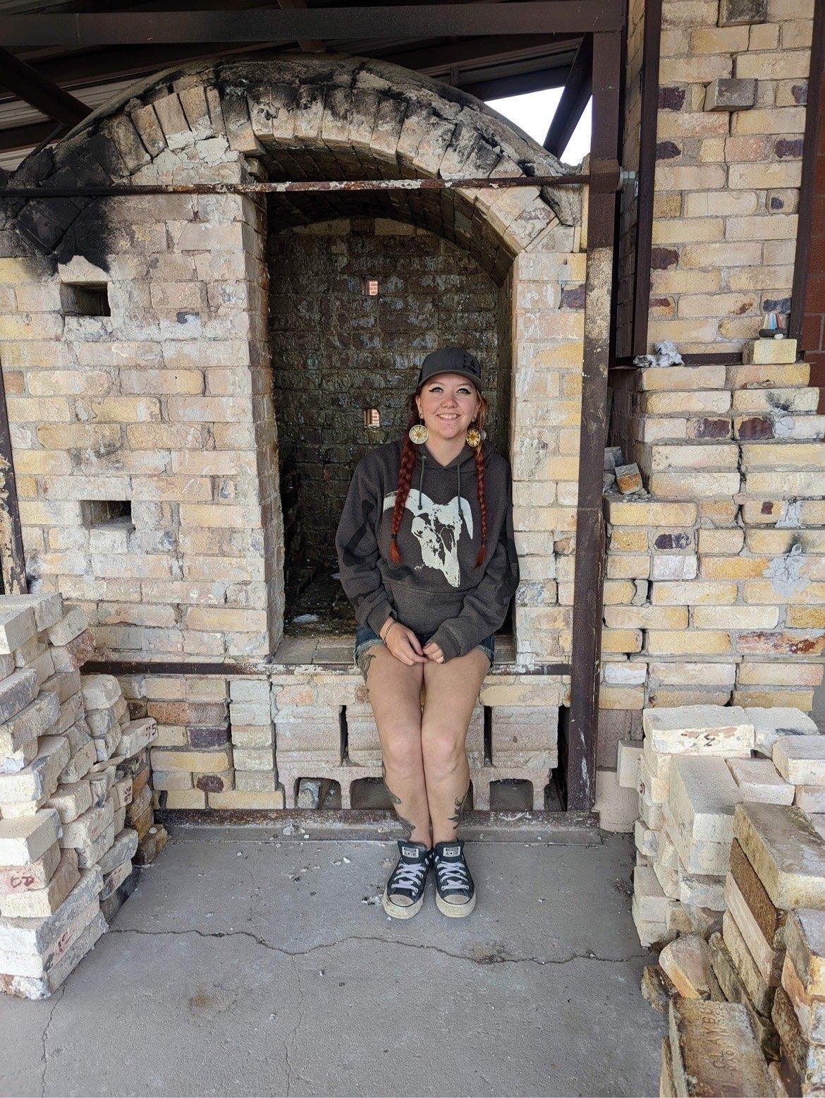 The Artist jordan sitting in a wood kiln